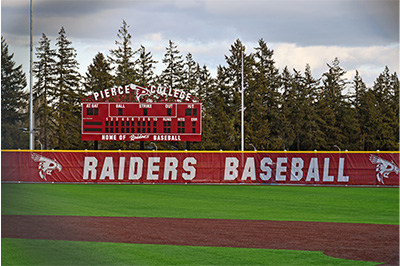 Photo of the Raiders Baseball home field at Fort Steilacoom Park featuring the Pierce College Raiders scoreboard