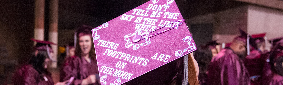 Graduate hat that says "Don't tell me the sky is the limit when there are footprints on the moon"