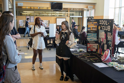 students gather around table advertising the Idol Club