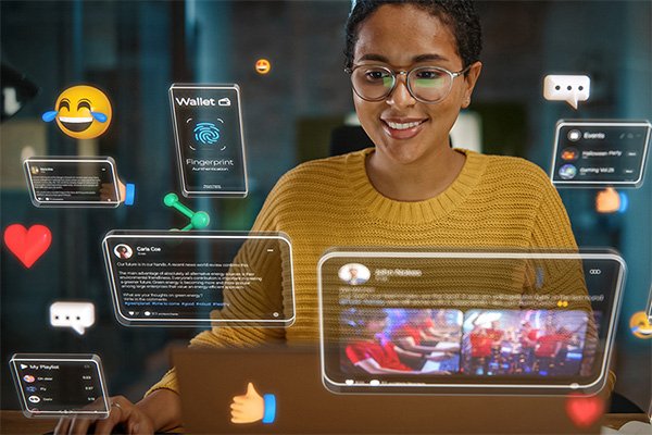person at laptop surrounded by images of social media posts and emoji