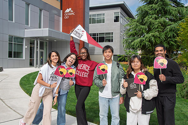group of students posing with cartoon bird signs