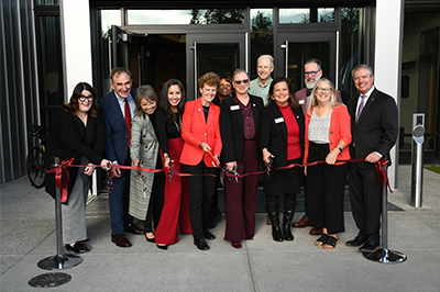 Pierce College Chancellor, Presidents and Board of Trustees all cut red ribbon in front of glass doors
