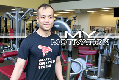 Tony Nguyen stands in the Health Education Center in front of exercise equipment