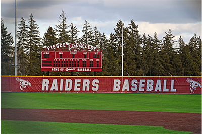 Photo of the Raiders Baseball home field at Fort Steilacoom Park featuring the Pierce College Raiders scoreboard