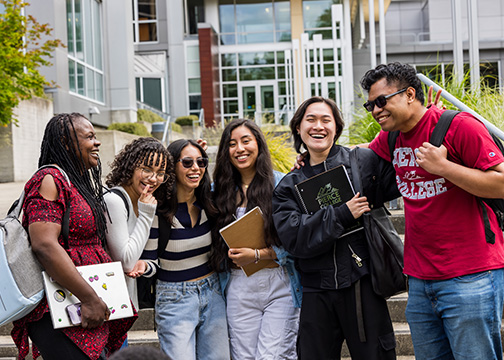 Students laughing in a large group outside Pierce College Fort Steilacoom