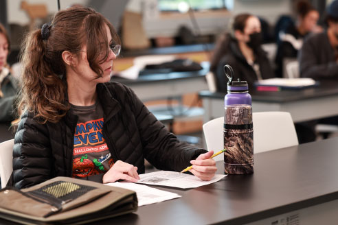 woman taking notes in classroom