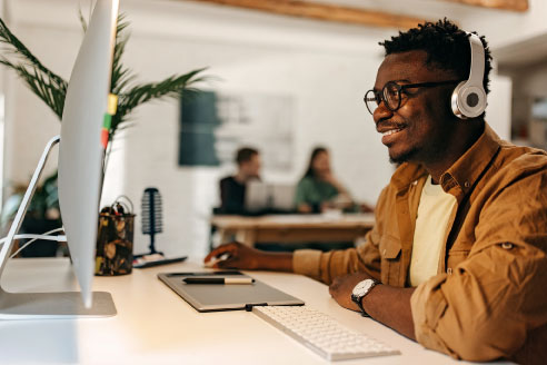 College student studying Business Information Technology, working on a computer.