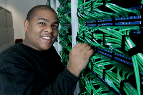 Student Working on Network Cables and Cybersecurity Projects
