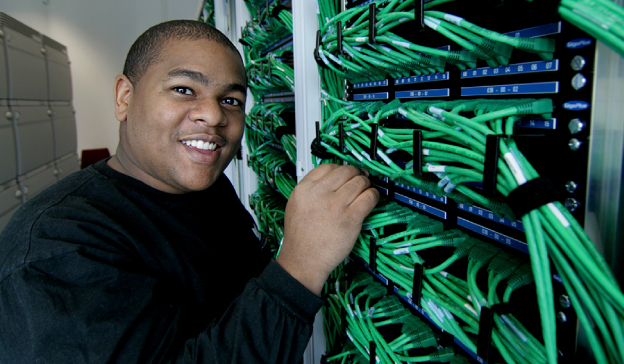 Student Working on Network Cables and Cybersecurity Projects