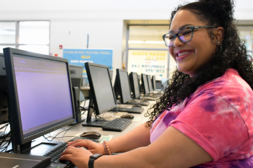 A focused student engaged in work at a computer