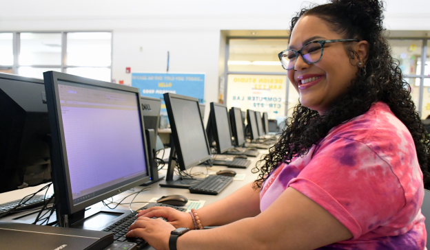A focused student engaged in work at a computer