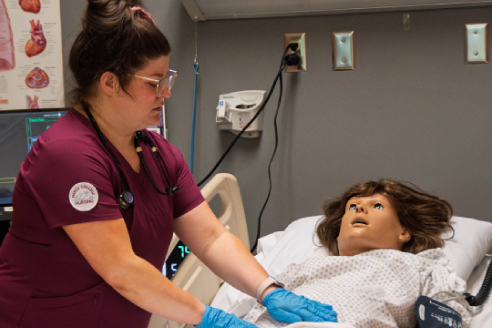 Nursing student working in a test lab on a test patient.