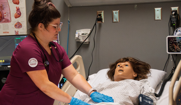 Nursing student working in a test lab on a test patient.