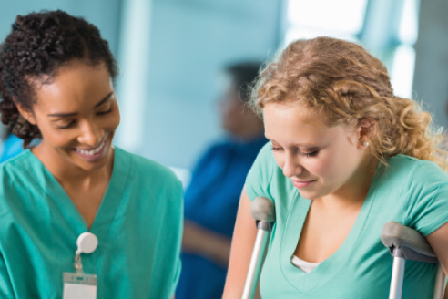 healthcare worker assisting woman on crutches