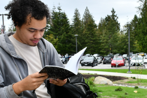 student reading book outdoors