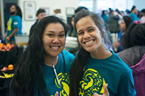 Two students smiling and embracing