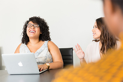 woman laughing with laptop