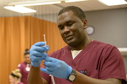 nursing student drawing syringe