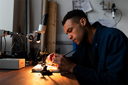 student using soldering iron