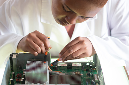 student repairing computer equipment