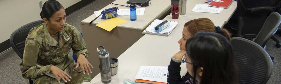 Student in uniform speaking to other students