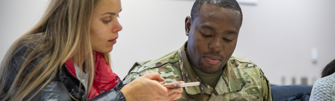 Student in uniform studying with another student