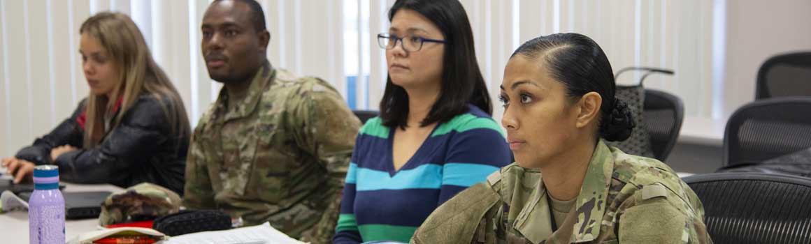 Students in uniform paying attention to instructor