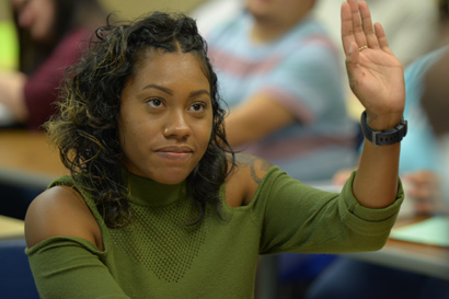 student raising hand in classroom