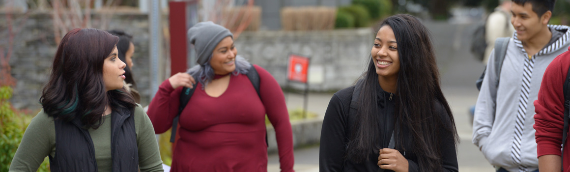 group of students walking and talking on fort steilacoom campus