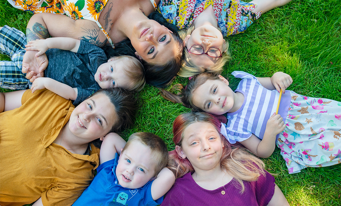 hayley ness lying in the grass with her children