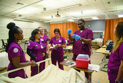 Nursing students interacting in laboratory