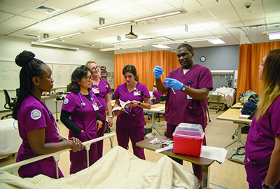 Nursing students interacting in laboratory Nursing students interacting in laboratory