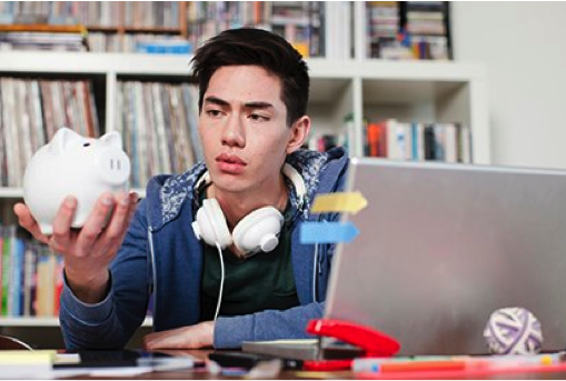 Student looking at piggy bank