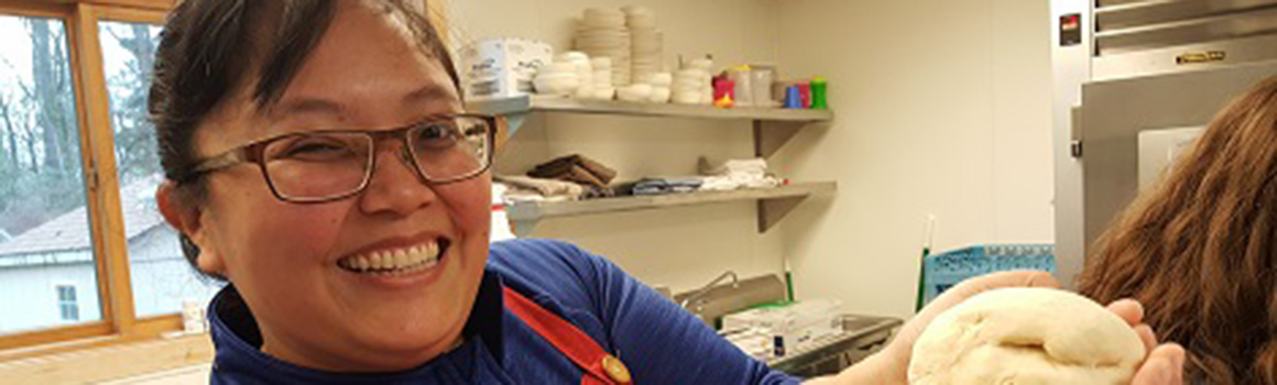 community and continuing education student making a bagel in class