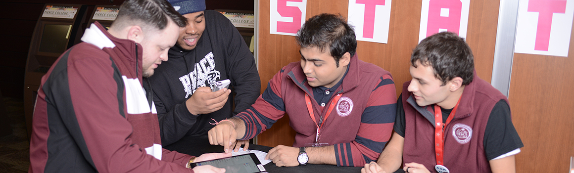 stat team members helping a students with their device stat team members helping a students with their device