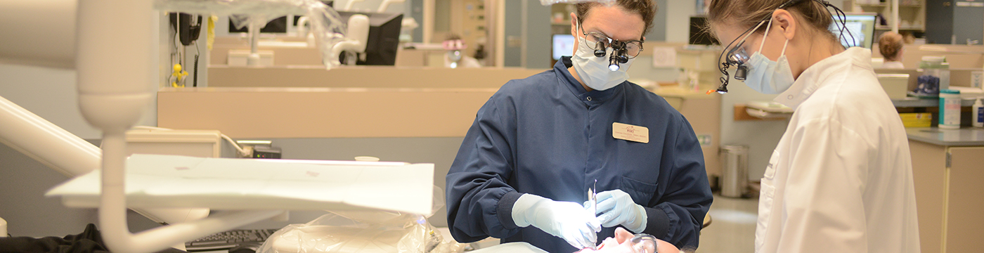 Dental Hygiene students working on a patient