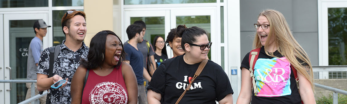 equity, diversity, and inclusion banner students walking out of building