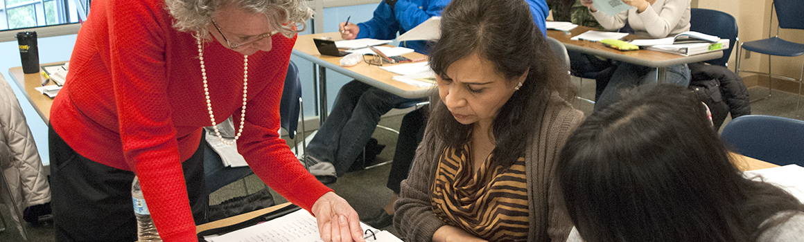 Faculty working with students at their desks