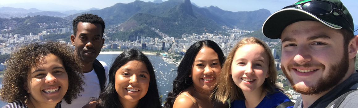 group of smiling students with view of brazil in background on a sunny day group of smiling students with view of brazil in background on a sunny day