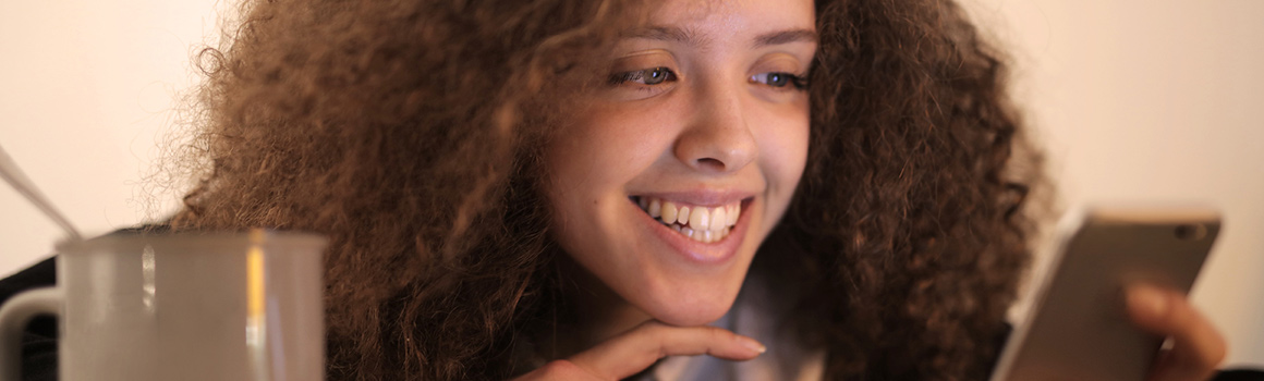 Woman smiling at phone