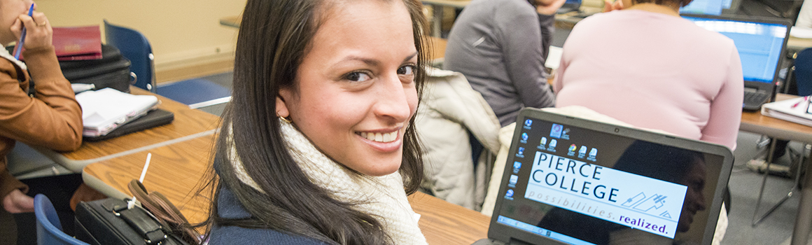 Student with laptop in a classroom