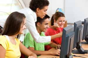 teacher and students teacher instructing students at computers