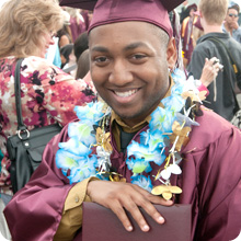 student in graduation gown and cap holding diploma student in graduation gown and cap holding diploma