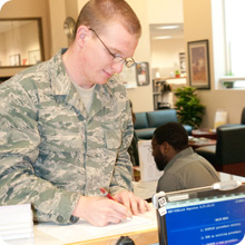 student in military uniform filling out form at counter student in military uniform filling out form at counter
