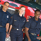 Firefighters standing in front of fire truck