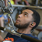 student using weight machine at health education center