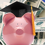 piggy bank wearing a tassel and graduation cap 