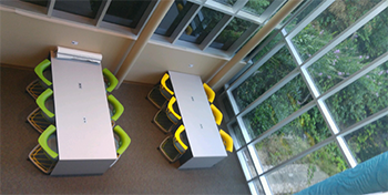 aerial view of makerspace work area with tables and chairs aerial view of makerspace work area with tables and chairs