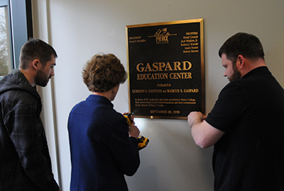 chancellor michele johnson opening the wall for time capsule